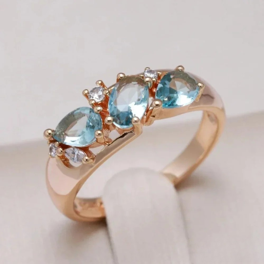 Gold ring with blue zircons